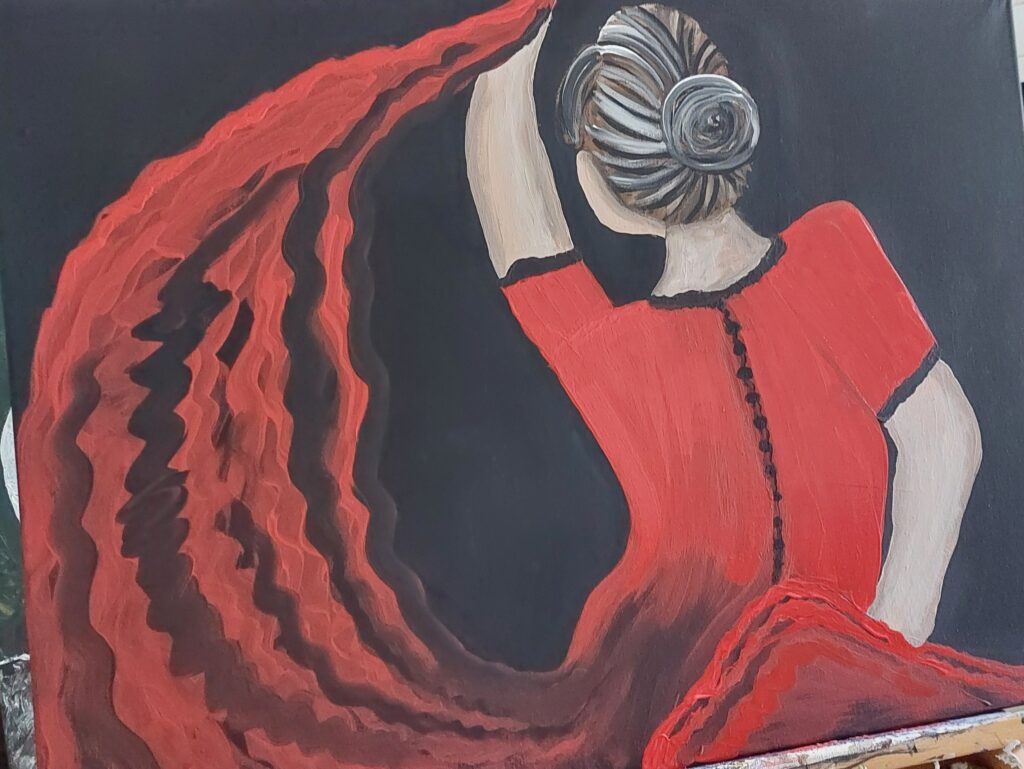 eine Flamencotänzerin von hinten, sie trägt ein rotes Kleid