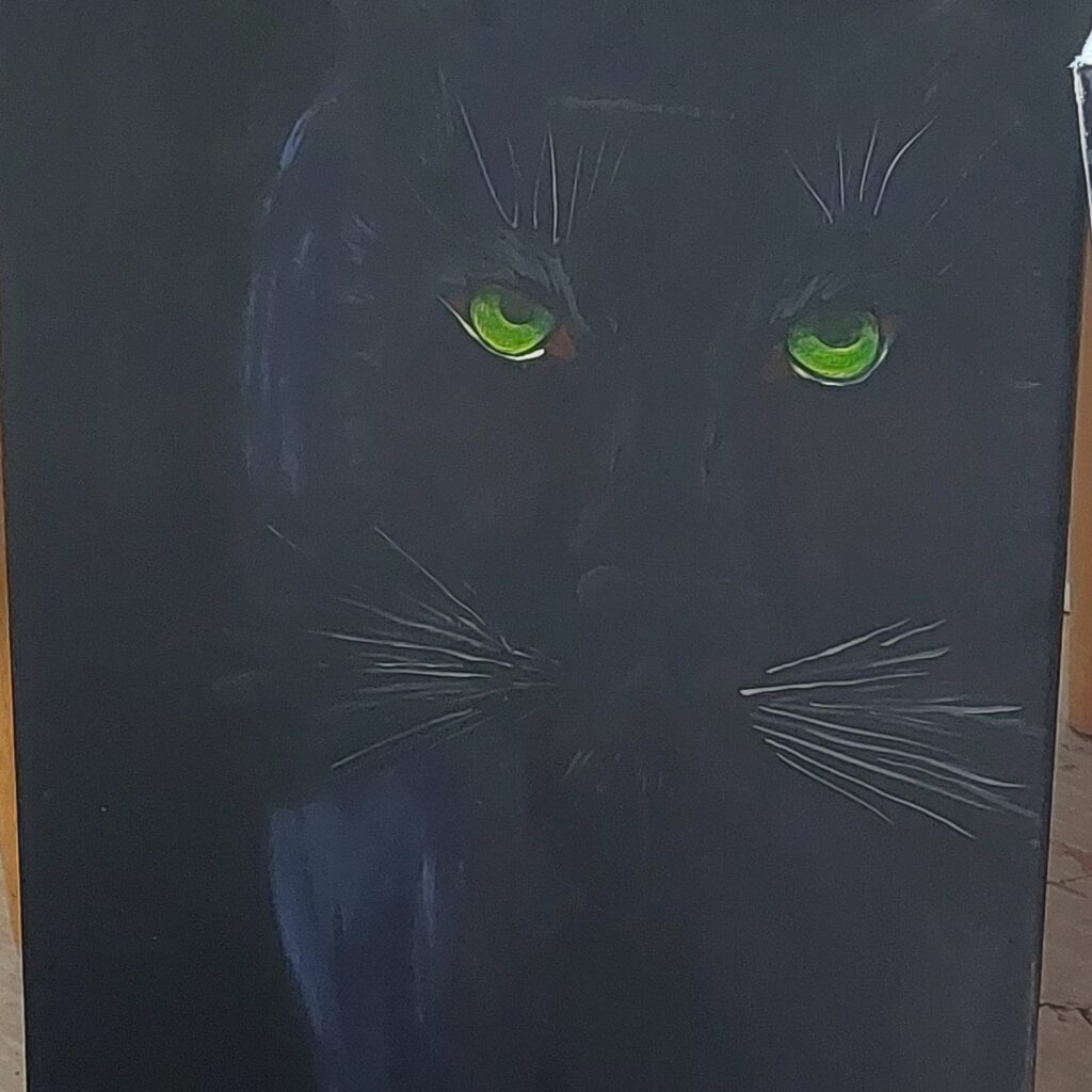 Ein schwarzer Panther, wirklich gut sichtbar sind nur die leuchtenden Augen, der rest verschwindet mehr und mehr im schwarzen Hintergrund
