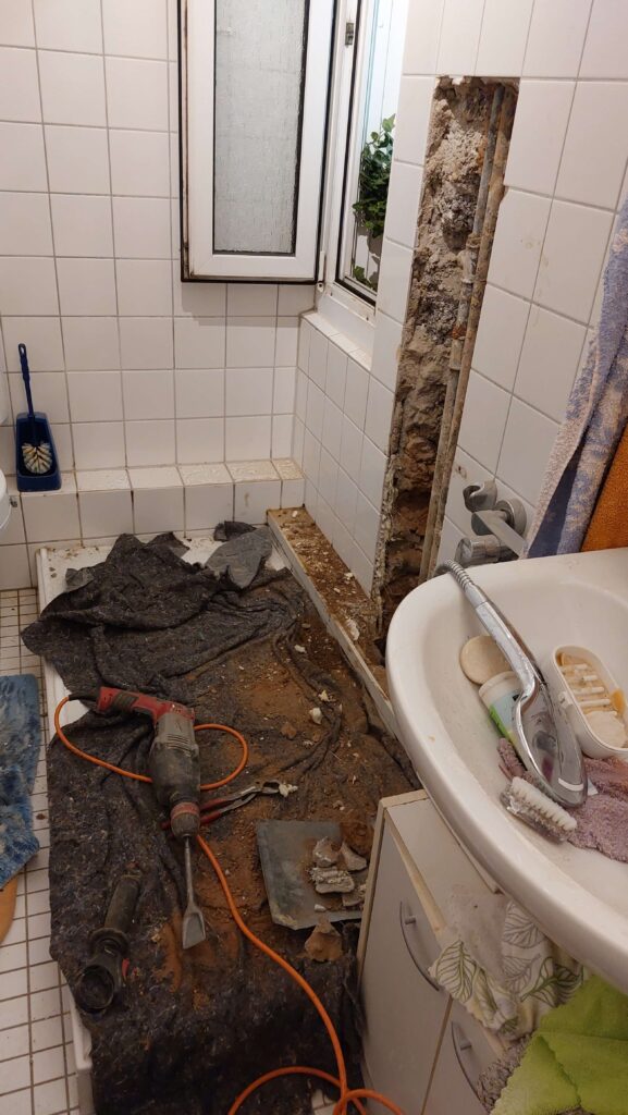 Mein Badezimmer, nachdem die Klemptner angefangen haben den Wasserrohrbruch zu beseitigen